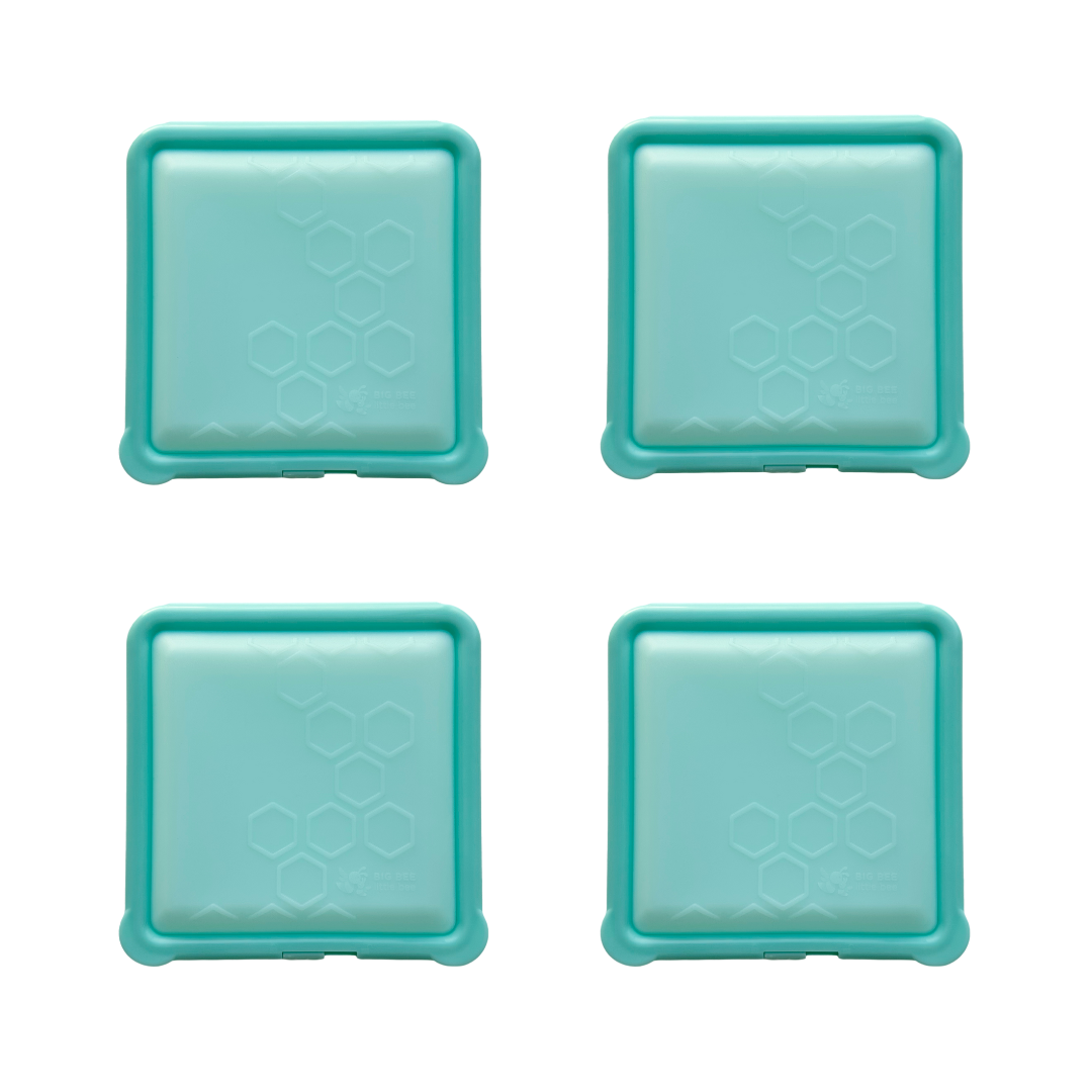 Four teal square containers with rounded corners, arranged in a two-by-two grid on a white background. Each lid features a subtle honeycomb pattern embossed on the surface.